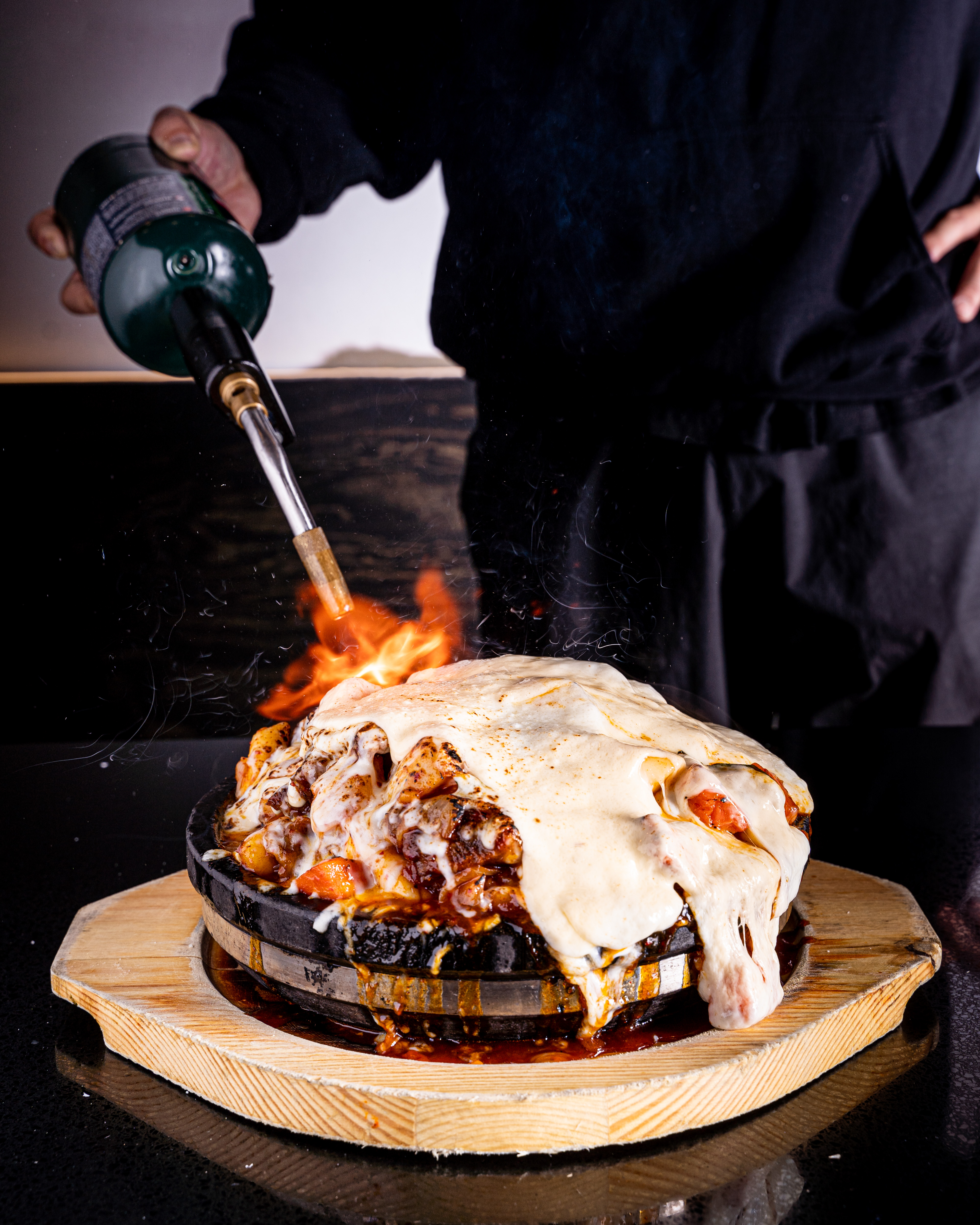 Daeho cheese Kalbijjim being finished with a torch